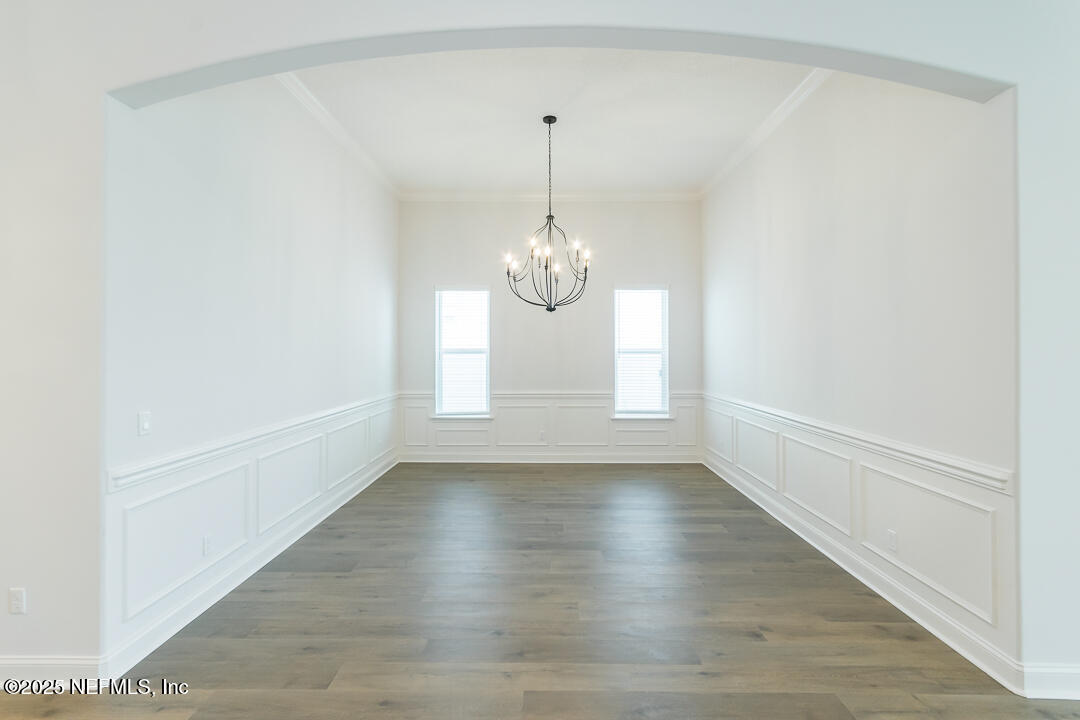 303 Eagle Moon Lake Drive St. Augustine, FL 32092 - Photo 14 of 35 a view of an empty room with wooden floor and a window