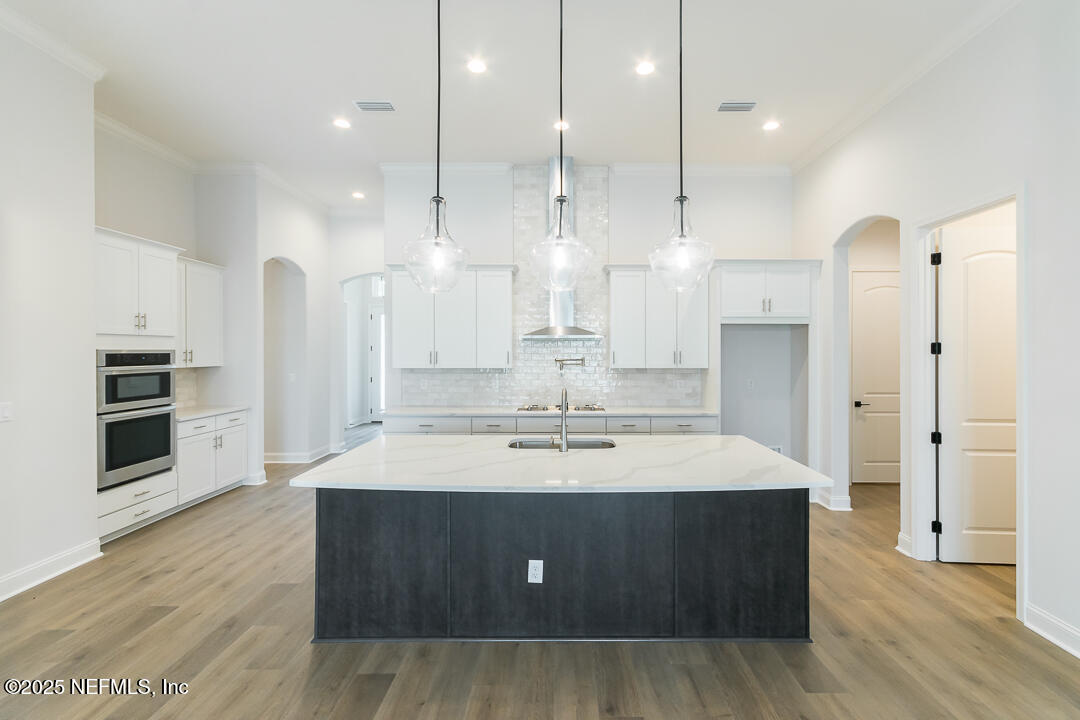 303 Eagle Moon Lake Drive St. Augustine, FL 32092 - Photo 15 of 35 a large kitchen with stainless steel appliances kitchen island a large counter top and a refrigerator