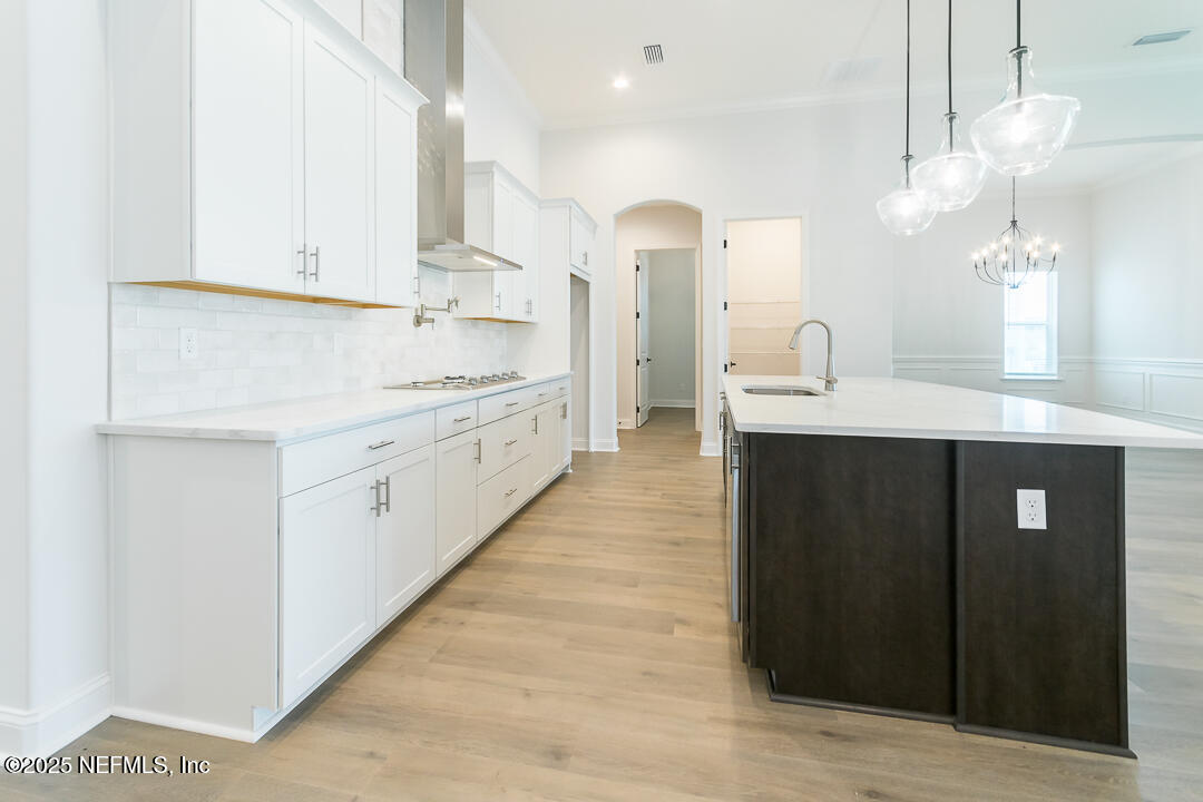 303 Eagle Moon Lake Drive St. Augustine, FL 32092 - Photo 16 of 35 a kitchen with stainless steel appliances kitchen island granite countertop a sink and cabinets