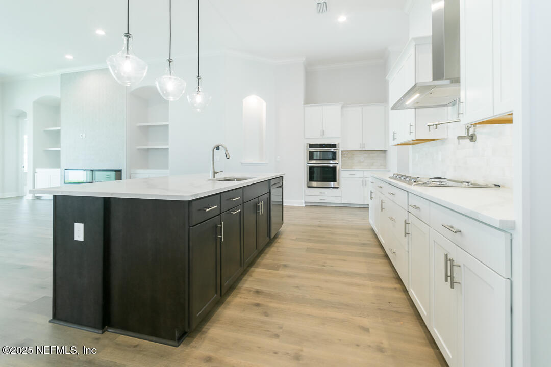 303 Eagle Moon Lake Drive St. Augustine, FL 32092 - Photo 17 of 35 a large kitchen with a sink and cabinets