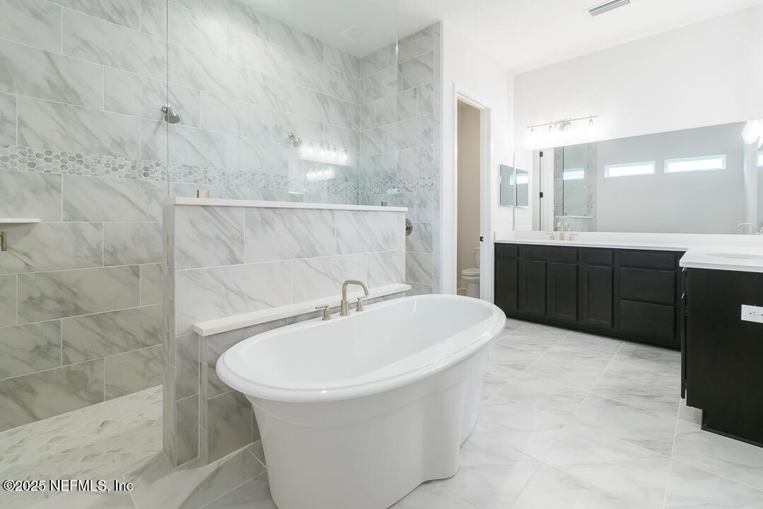 303 Eagle Moon Lake Drive St. Augustine, FL 32092 - Photo 21 of 35 a bathroom with a sink and a bathtub