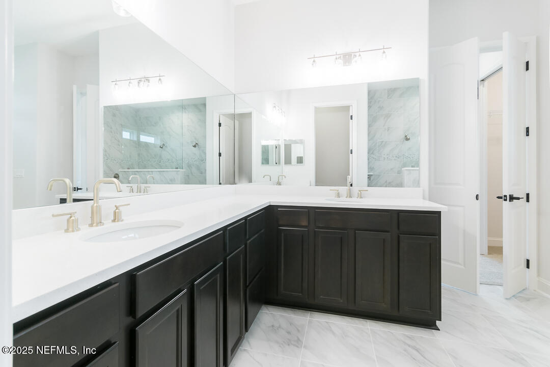 303 Eagle Moon Lake Drive St. Augustine, FL 32092 - Photo 22 of 35 a bathroom with a double vanity sink mirror and double