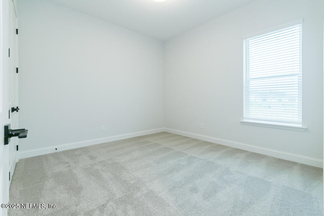 303 Eagle Moon Lake Drive St. Augustine, FL 32092 - Photo 25 of 35 an empty room with a window