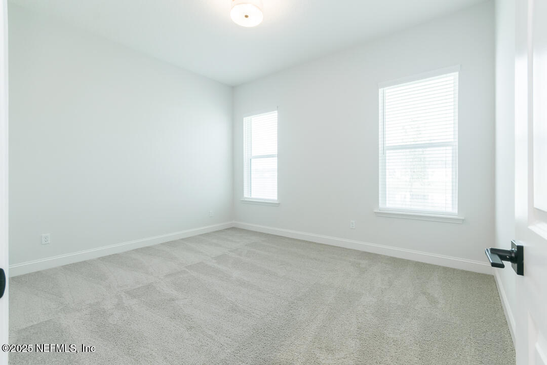 303 Eagle Moon Lake Drive St. Augustine, FL 32092 - Photo 27 of 35 an empty room with a window