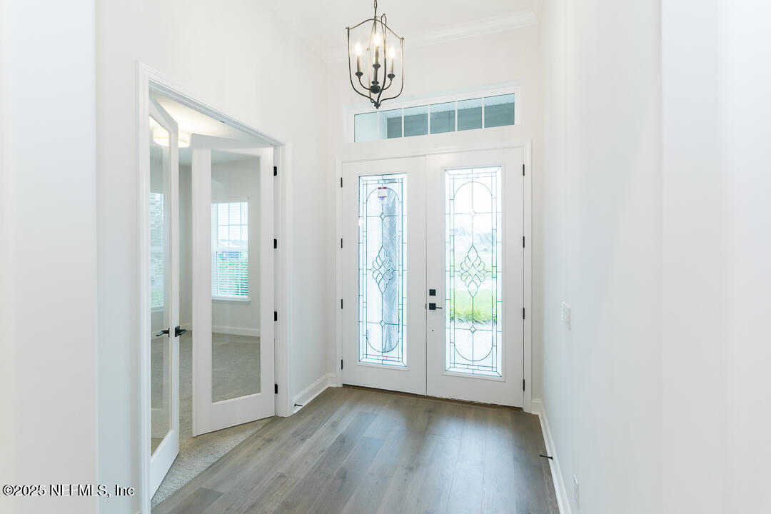 303 Eagle Moon Lake Drive St. Augustine, FL 32092 - Photo 4 of 35 a view of a hallway with wooden floor and closet