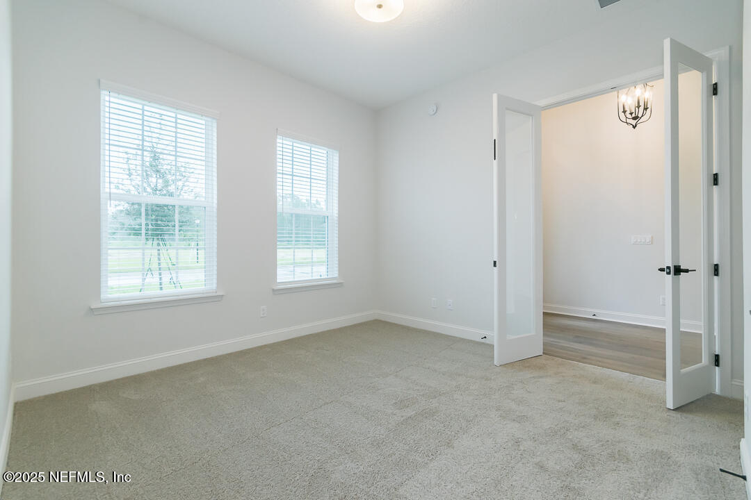 303 Eagle Moon Lake Drive St. Augustine, FL 32092 - Photo 6 of 35 an empty room with windows