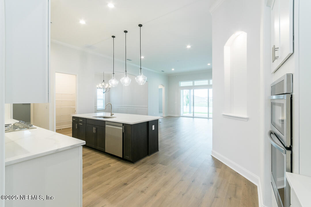 303 Eagle Moon Lake Drive St. Augustine, FL 32092 - Photo 7 of 35 a kitchen with stainless steel appliances granite countertop a sink a refrigerator and a stove