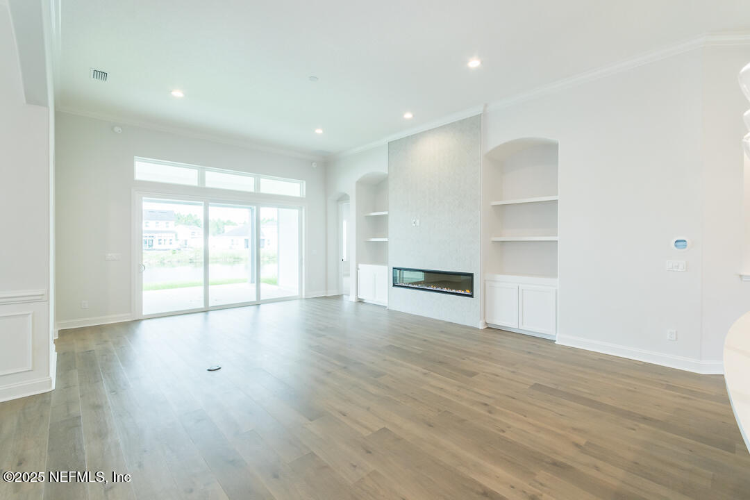 303 Eagle Moon Lake Drive St. Augustine, FL 32092 - Photo 9 of 35 a view of empty room with wooden floor and window