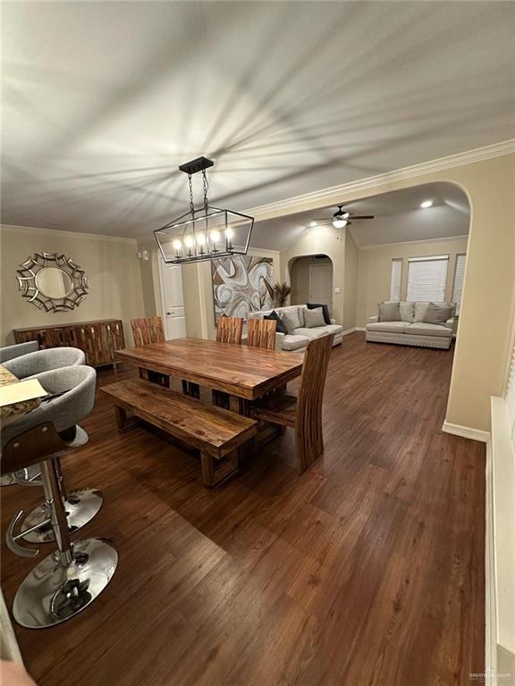 4608 Robin Avenue McAllen, TX 78504 - Photo 4 of 12 Open-concept interior featuring wood-finish flooring, a contemporary linear chandelier, crown molding, and recessed lighting