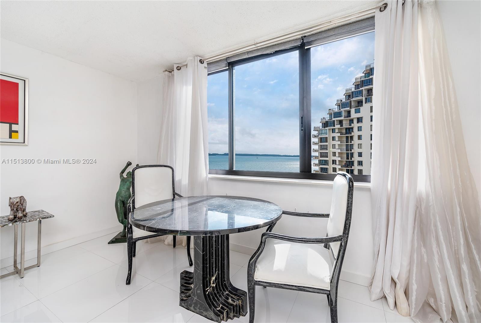 540 Brickell Key Drive, Unit 905 Miami, FL 33131 - Photo 12 of 43 a dining room with furniture and window