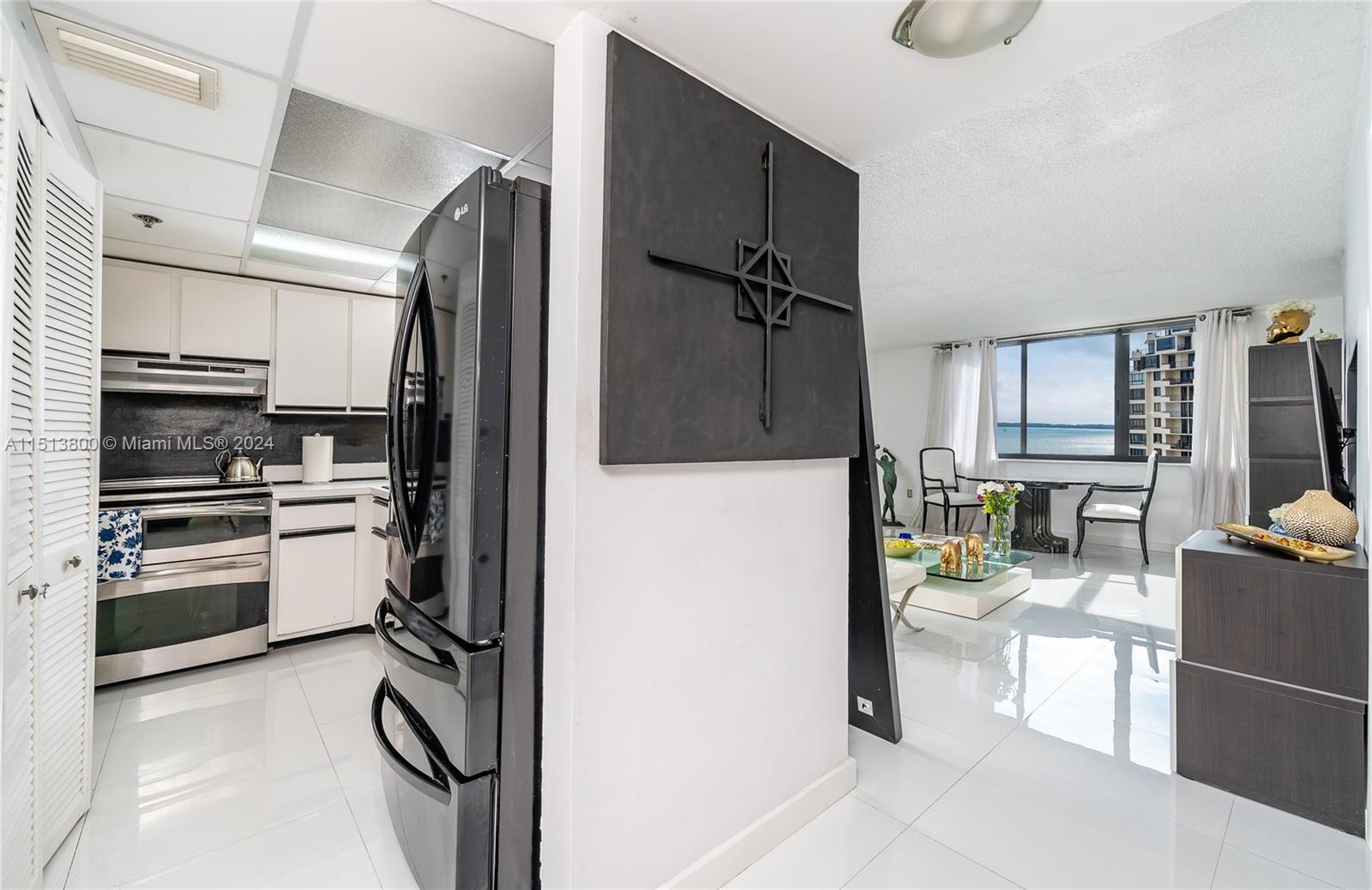 540 Brickell Key Drive, Unit 905 Miami, FL 33131 - Photo 13 of 43 a kitchen with a refrigerator and a stove top oven