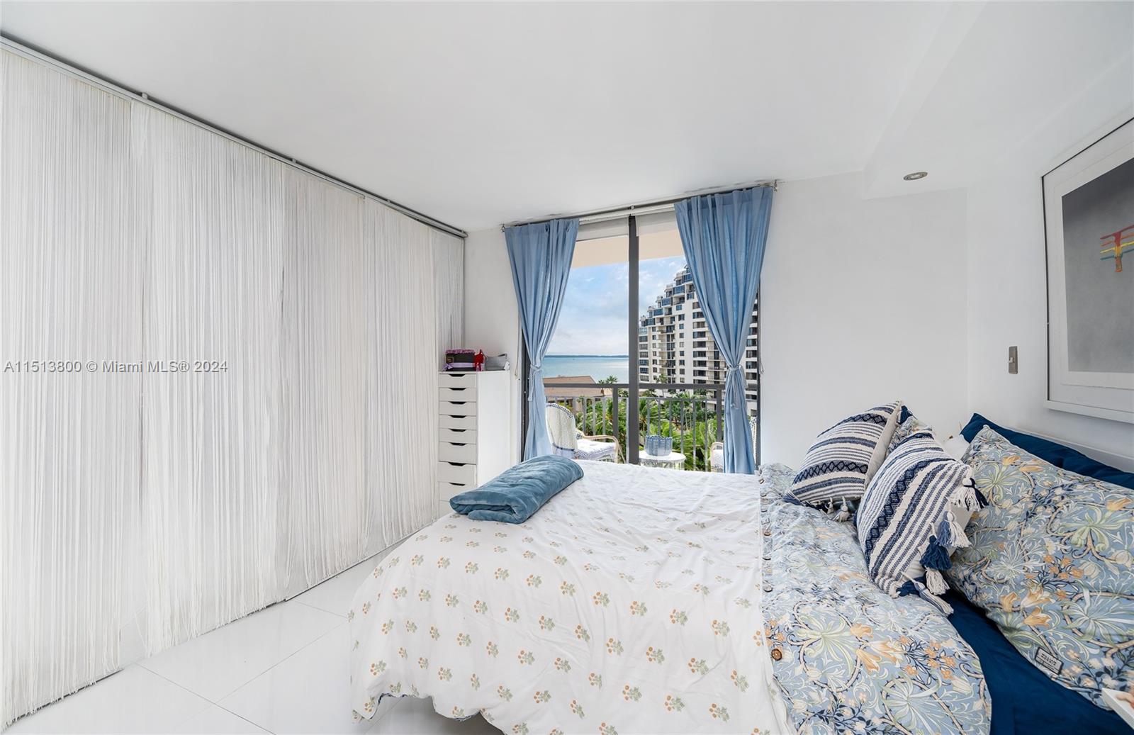 540 Brickell Key Drive, Unit 905 Miami, FL 33131 - Photo 14 of 43 a bedroom with a bed and a window
