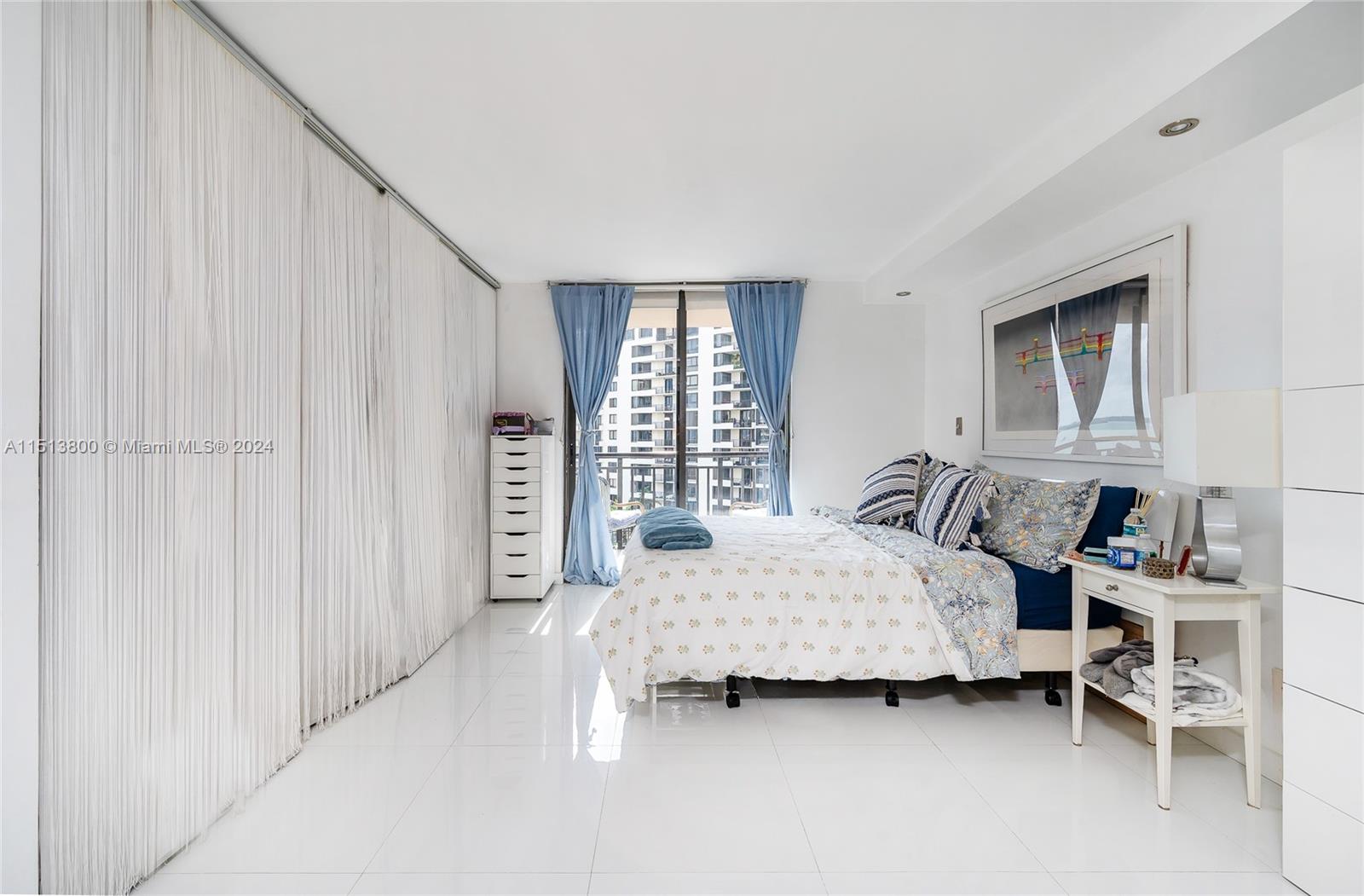 540 Brickell Key Drive, Unit 905 Miami, FL 33131 - Photo 15 of 43 a bedroom with a bed and a window