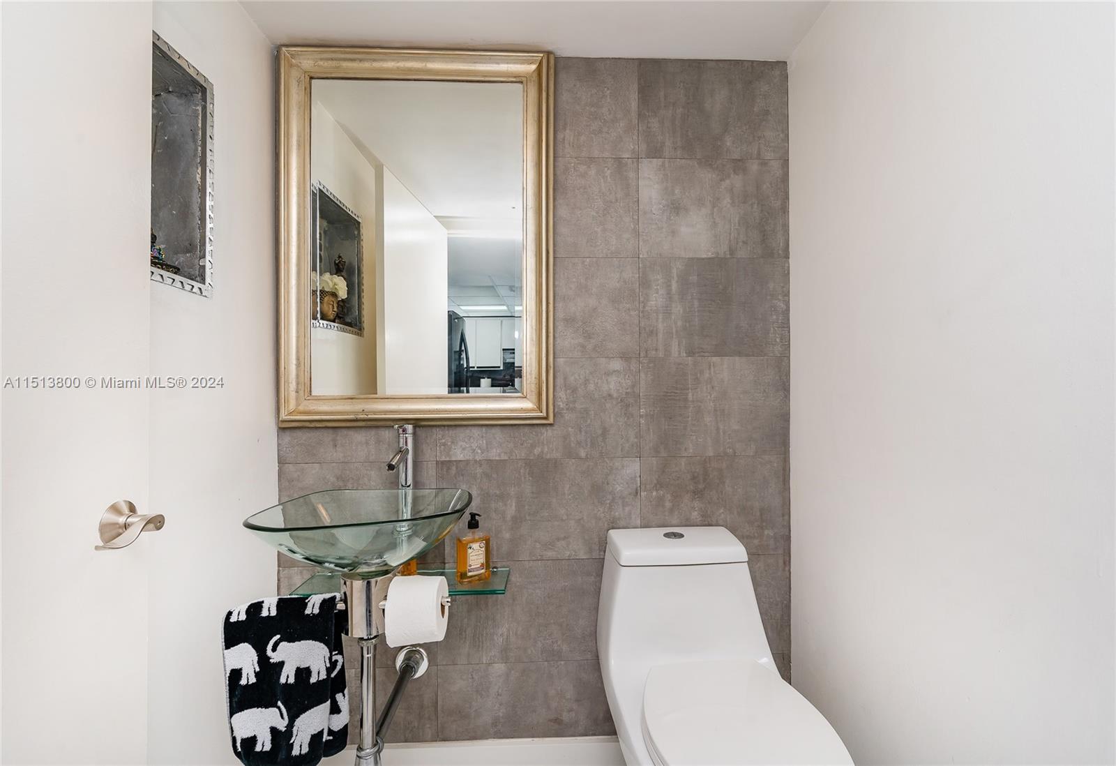 540 Brickell Key Drive, Unit 905 Miami, FL 33131 - Photo 18 of 43 a bathroom with a toilet a sink and mirror