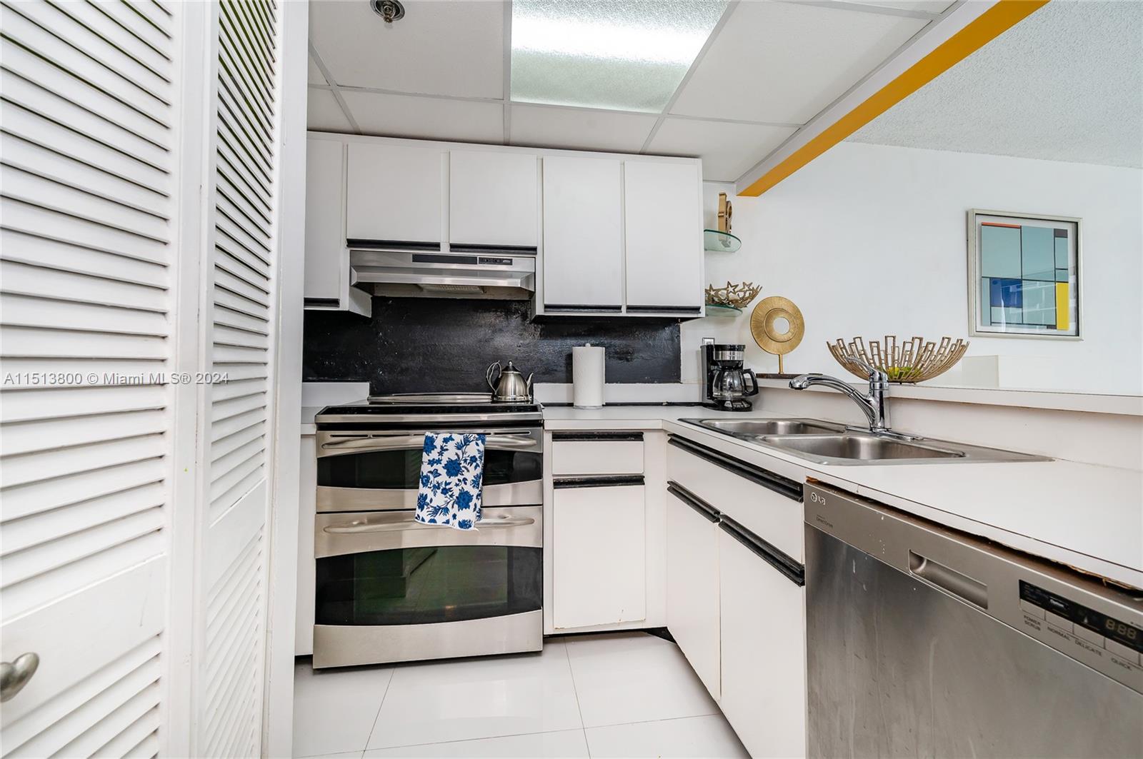 540 Brickell Key Drive, Unit 905 Miami, FL 33131 - Photo 20 of 43 a kitchen with stainless steel appliances a stove and a sink