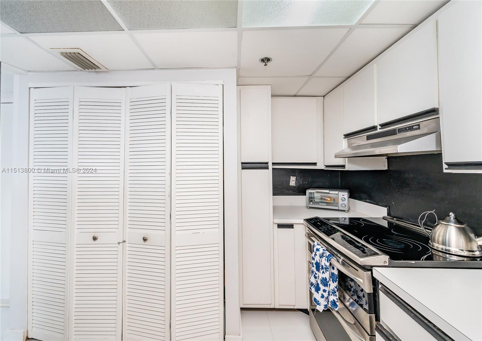 540 Brickell Key Drive, Unit 905 Miami, FL 33131 - Photo 21 of 43 a kitchen with stainless steel appliances and white cabinets