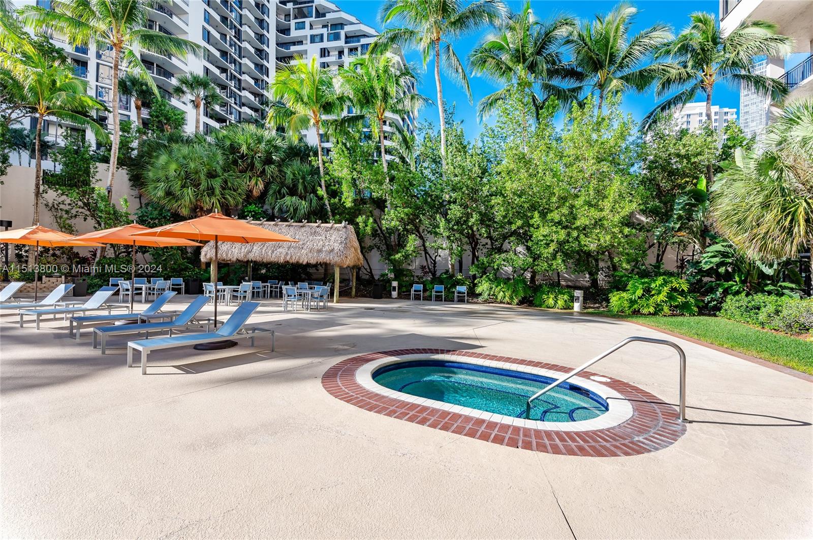 540 Brickell Key Drive, Unit 905 Miami, FL 33131 - Photo 31 of 43 a view of swimming pool with lawn chairs under an umbrella