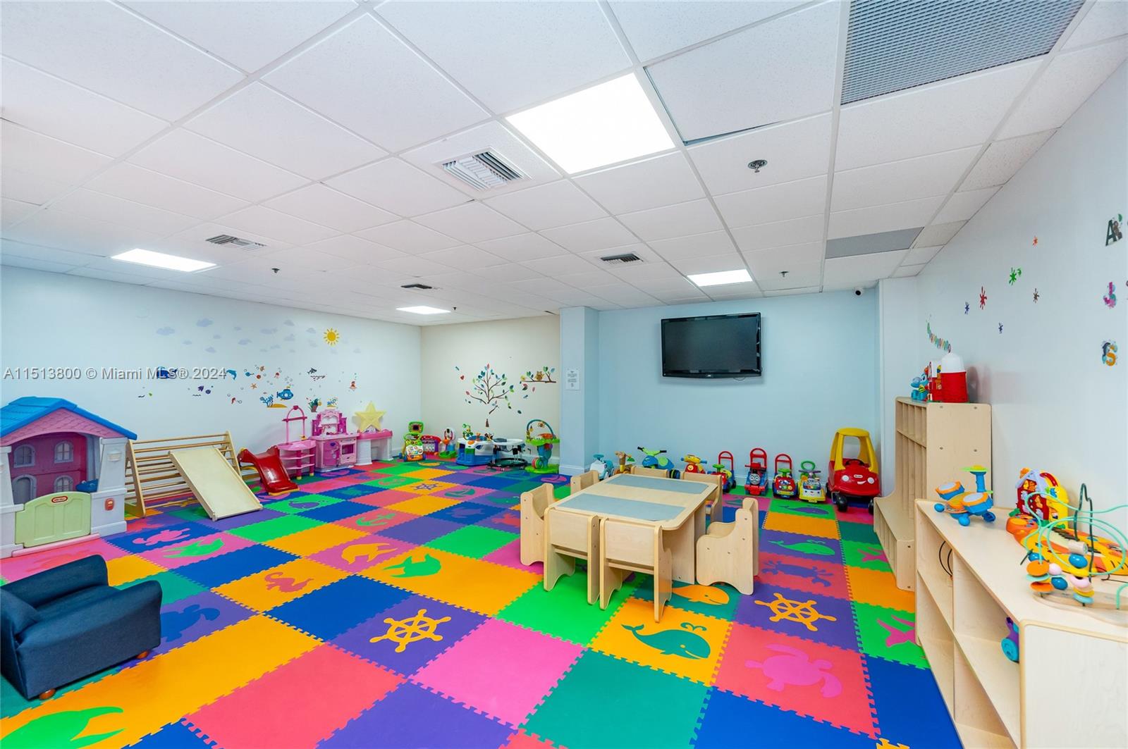 540 Brickell Key Drive, Unit 905 Miami, FL 33131 - Photo 36 of 43 a room that has a baby crib toys and a couch