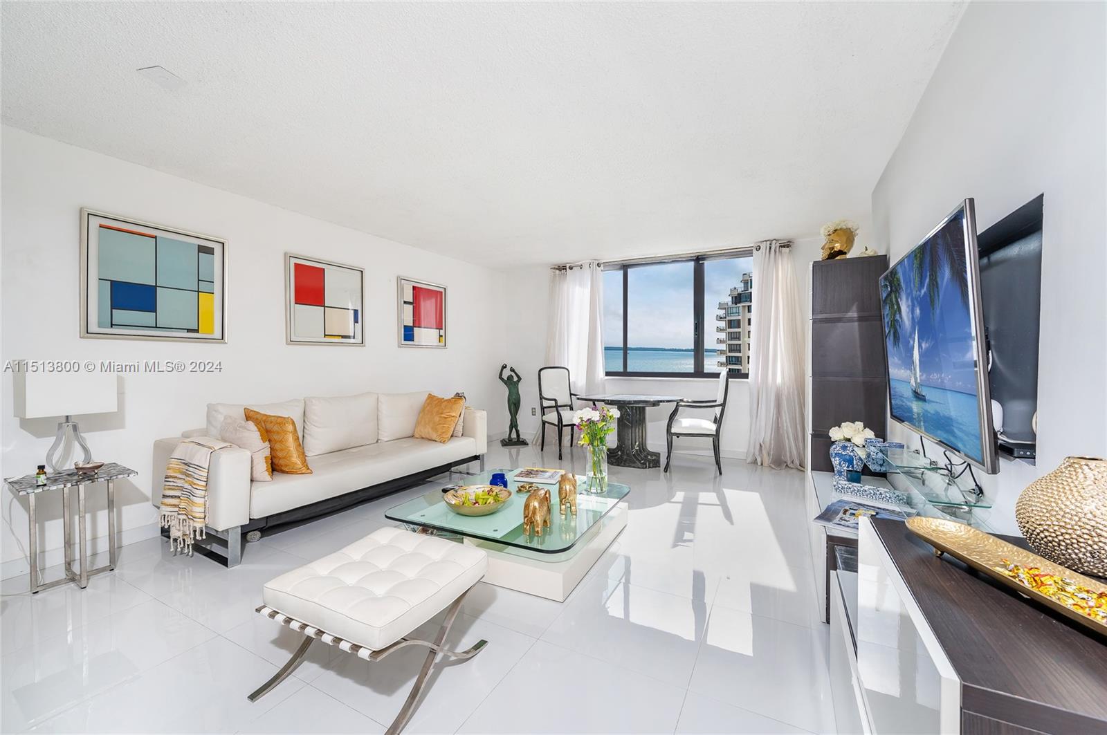 540 Brickell Key Drive, Unit 905 Miami, FL 33131 - Photo 8 of 43 a living room with furniture and a flat screen tv