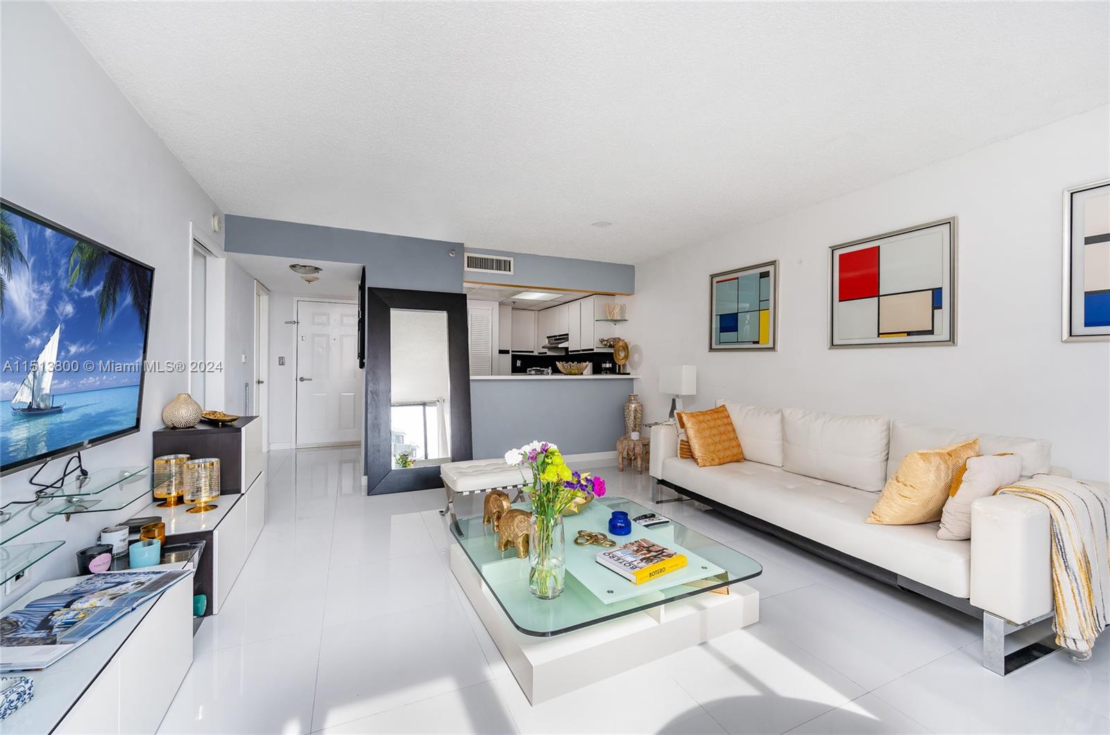 540 Brickell Key Drive, Unit 905 Miami, FL 33131 - Photo 9 of 43 a living room with furniture and a flat screen tv