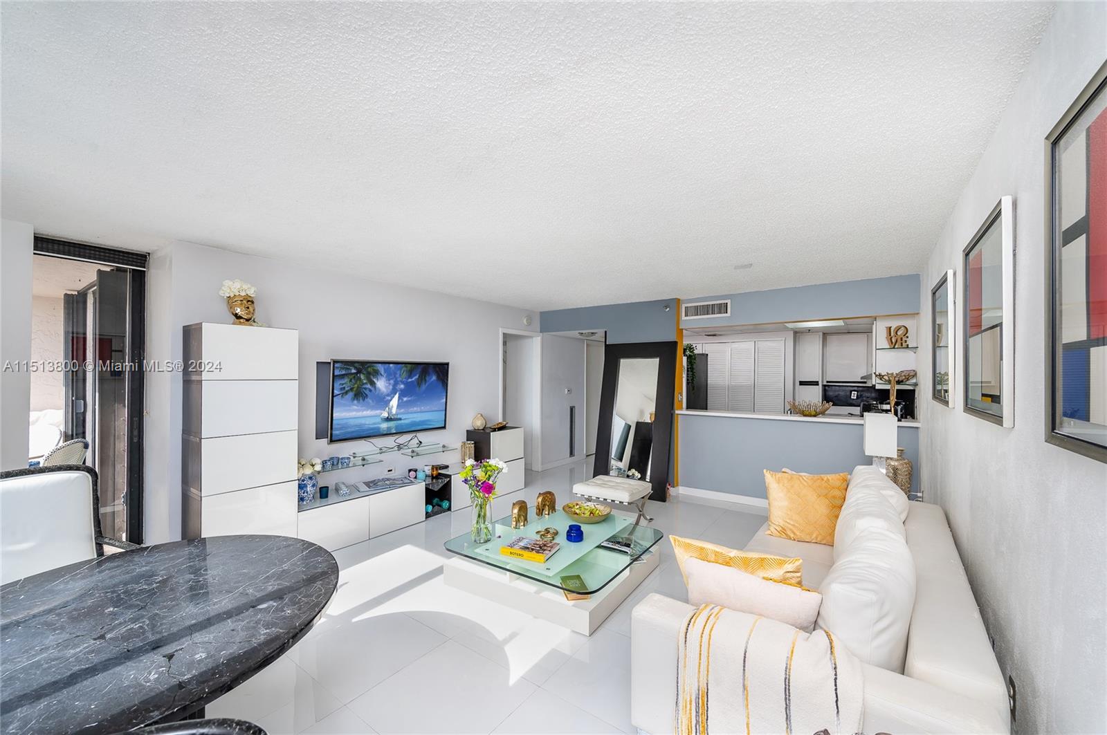540 Brickell Key Drive, Unit 905 Miami, FL 33131 - Photo 10 of 43 a living room with furniture and a flat screen tv