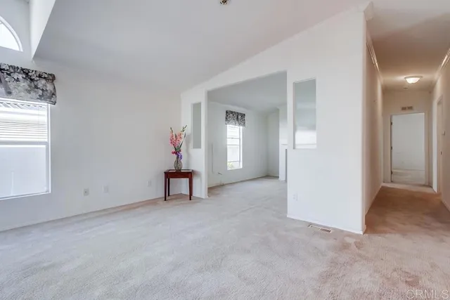 an empty room with windows and outdoor view