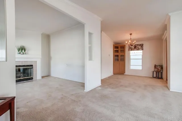 a view of empty room with a fireplace