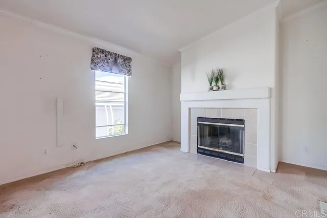a view of an empty room with a fireplace
