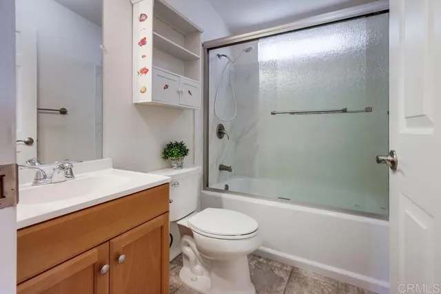 a bathroom with a shower a toilet and a tub