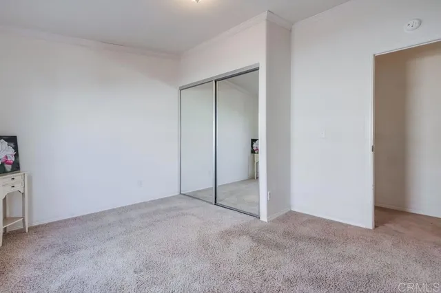 an empty room with windows and closet