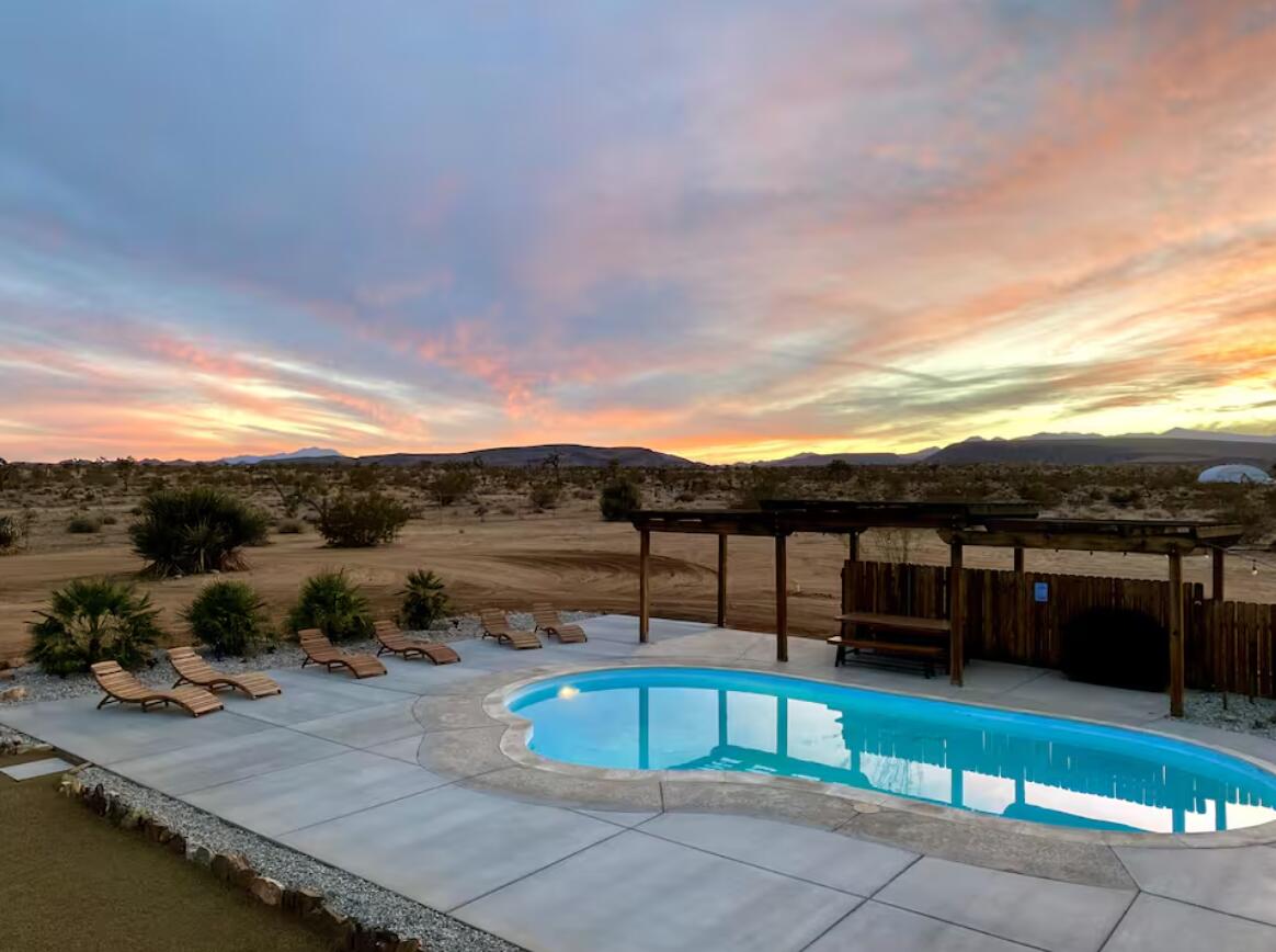 57725 Junipero Trail Yucca Valley, CA 92284 - Photo 1 of 46 a view of a swimming pool with a lounge chair
