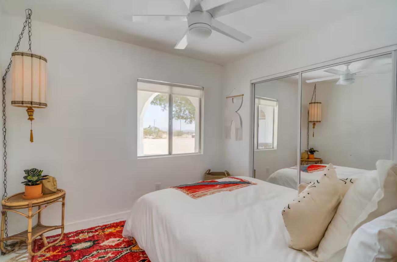 57725 Junipero Trail Yucca Valley, CA 92284 - Photo 14 of 46 a bedroom with a bed and a window