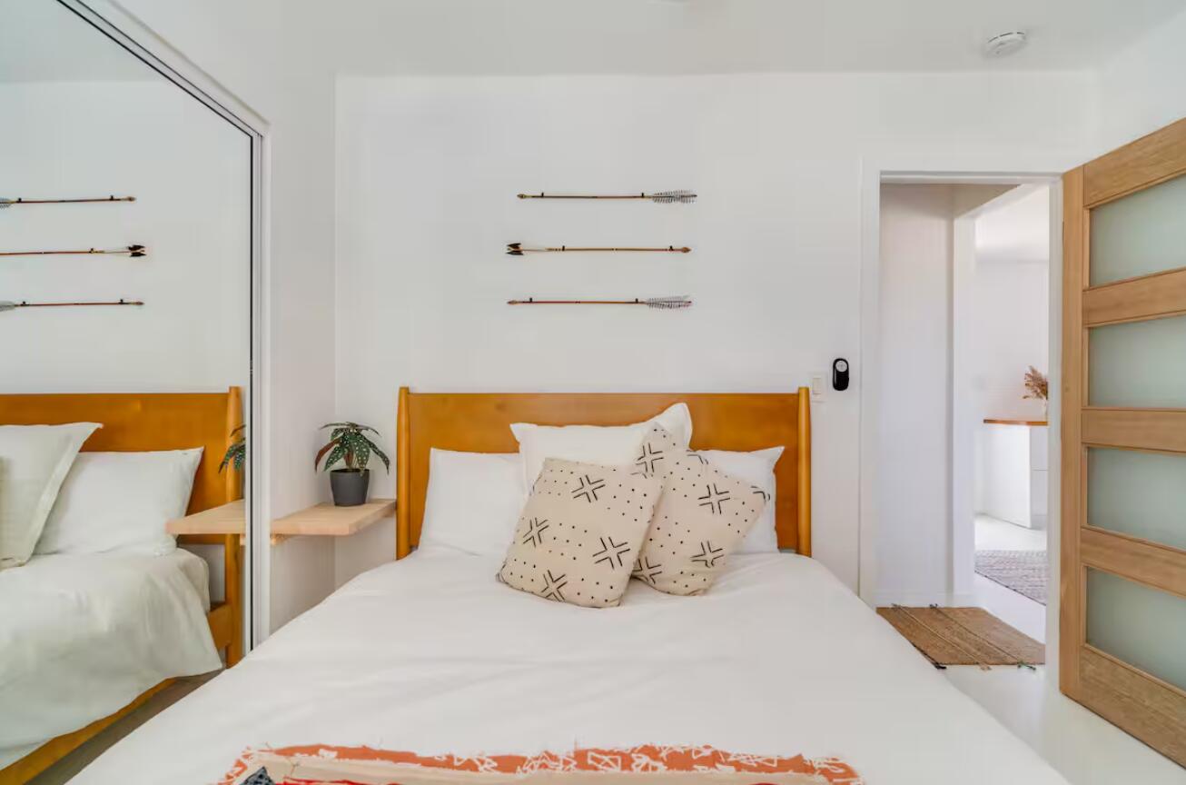 57725 Junipero Trail Yucca Valley, CA 92284 - Photo 15 of 46 a bedroom with a bed and wooden floor