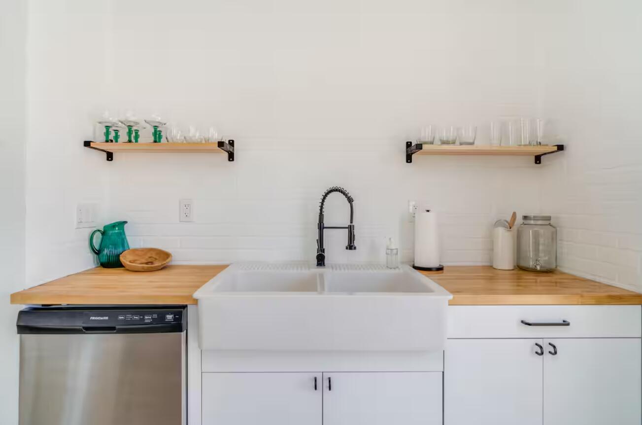 57725 Junipero Trail Yucca Valley, CA 92284 - Photo 20 of 46 a kitchen with a sink and a stove with wooden floor