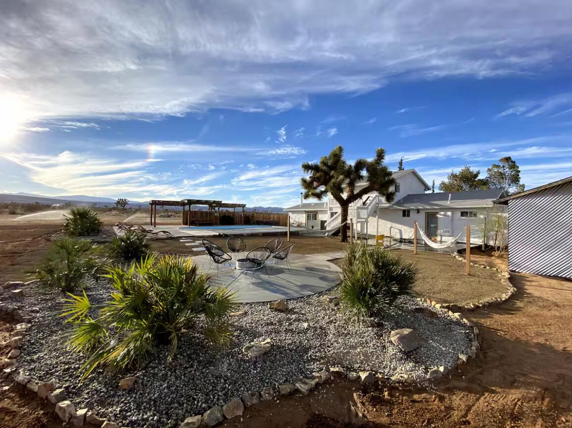 57725 Junipero Trail Yucca Valley, CA 92284 - Photo 30 of 46 a view of a lake with a building in the background