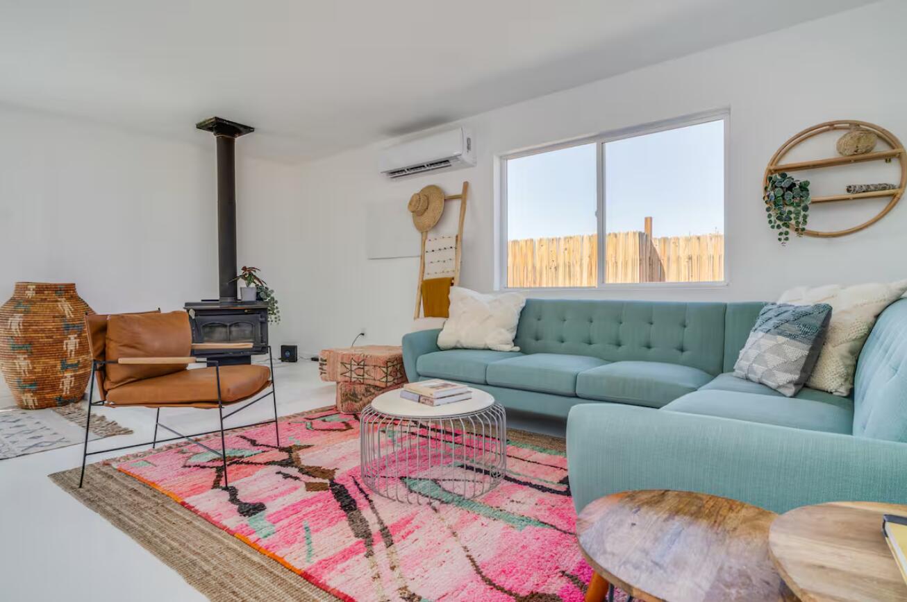 57725 Junipero Trail Yucca Valley, CA 92284 - Photo 5 of 46 a living room with furniture a rug and a chandelier