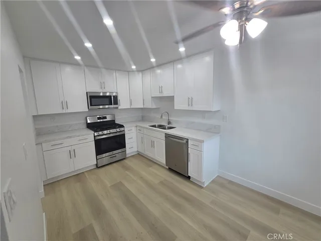 a kitchen with a stove a sink and a microwave