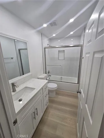 a bathroom with a double vanity sink and mirror with shower