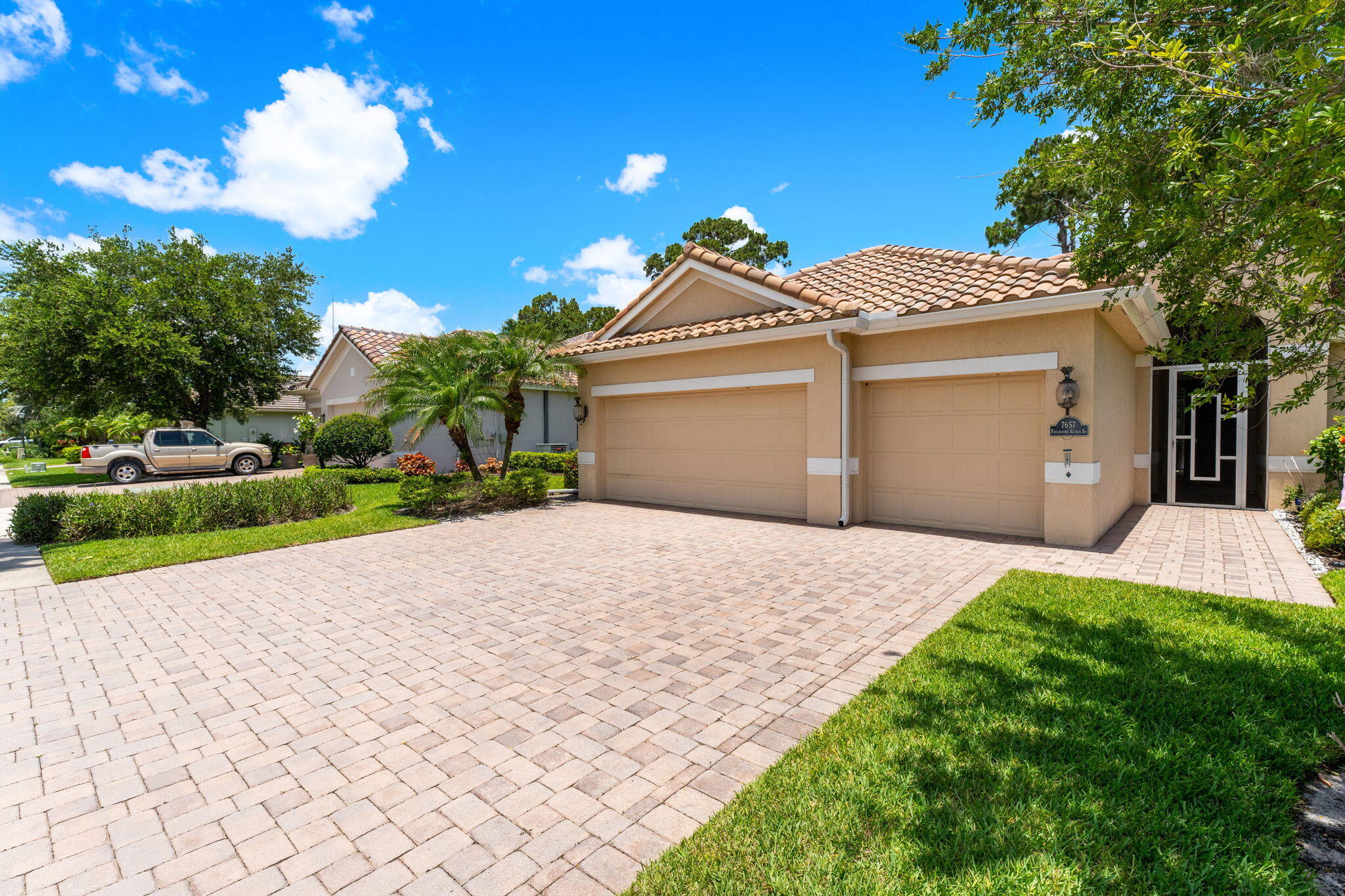 7657 Fieldstone Ranch Square Vero Beach, FL 32967 - Photo 43 of 52 a front view of a house with a yard and garage