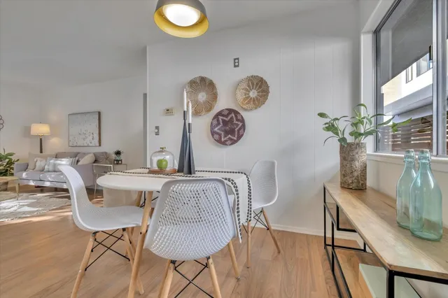 a view of a dining room with furniture and wooden floor