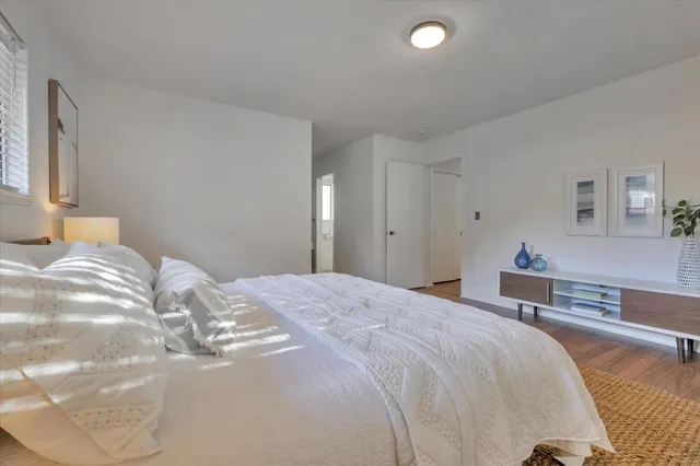 a bedroom with a bed and a couch