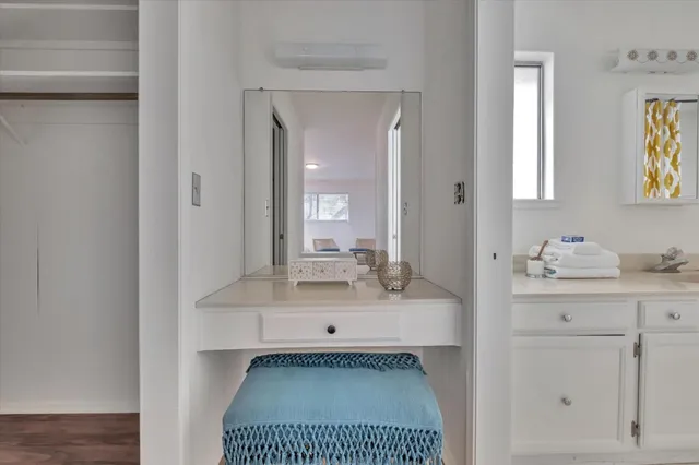 a bathroom with a sink vanity granite and a mirror