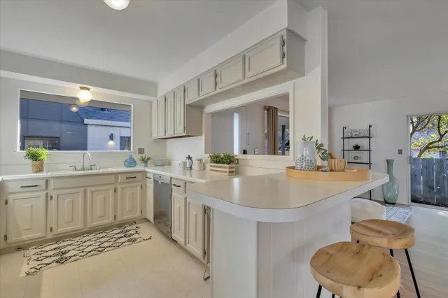 a kitchen with a sink cabinets and wooden floor