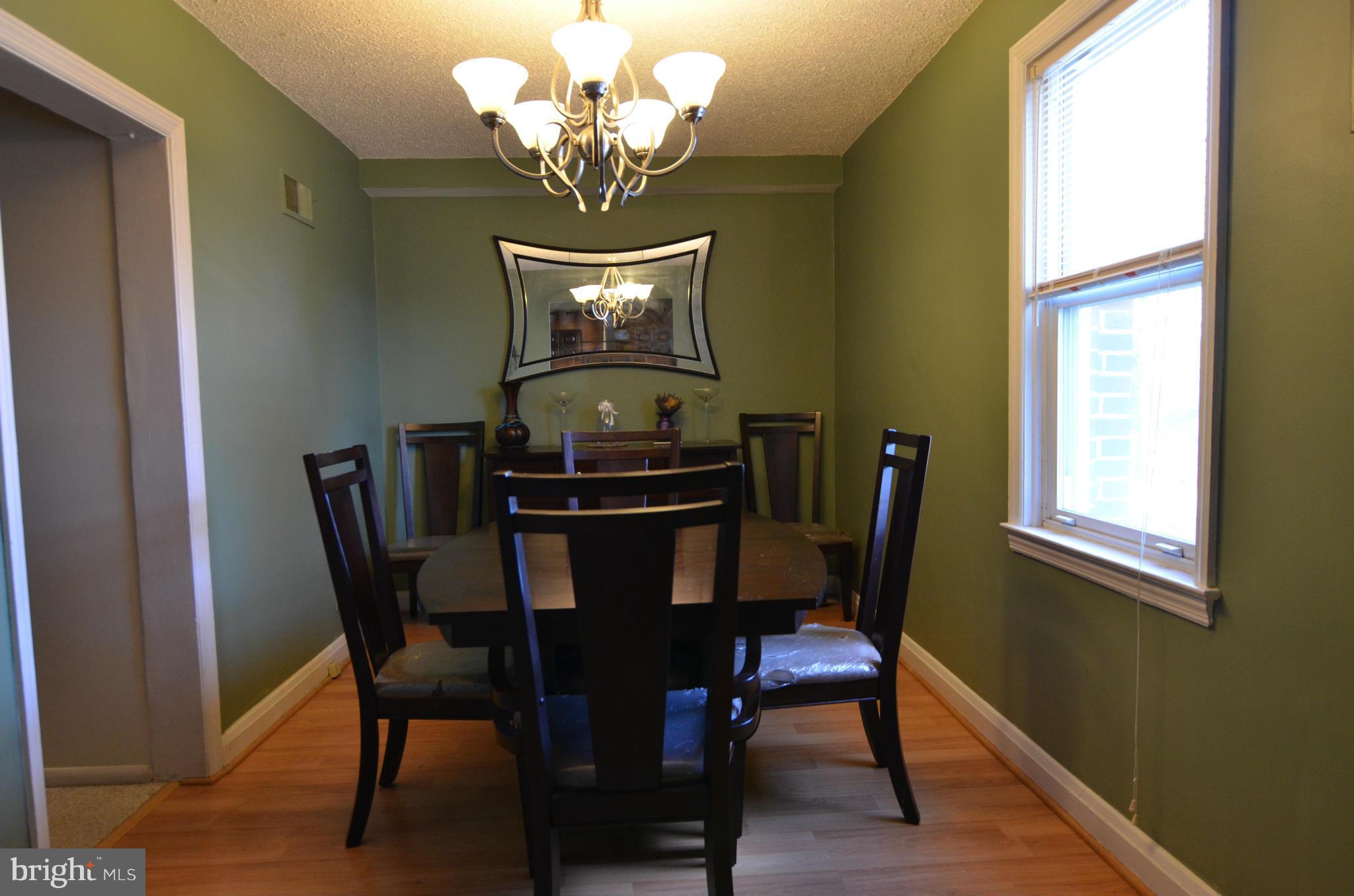 600 Old Riverside Road Baltimore, MD 21225 - Photo 2 of 15 a view of a dining room with furniture and chandelier