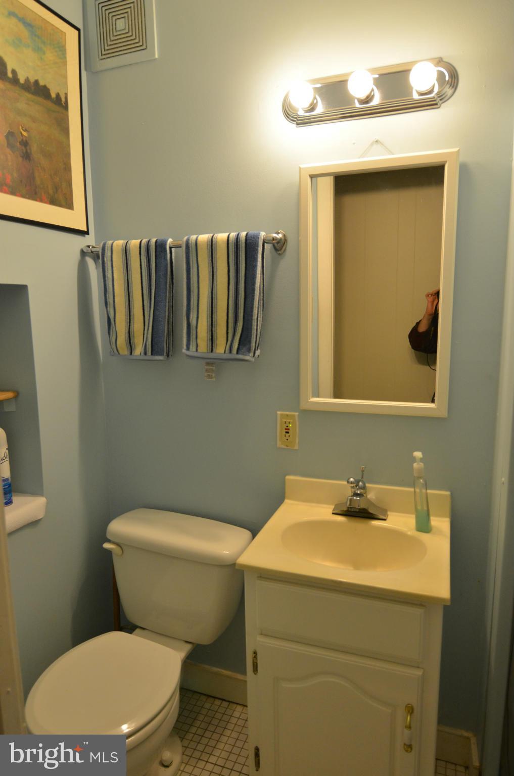 600 Old Riverside Road Baltimore, MD 21225 - Photo 3 of 15 a bathroom with a toilet sink and mirror