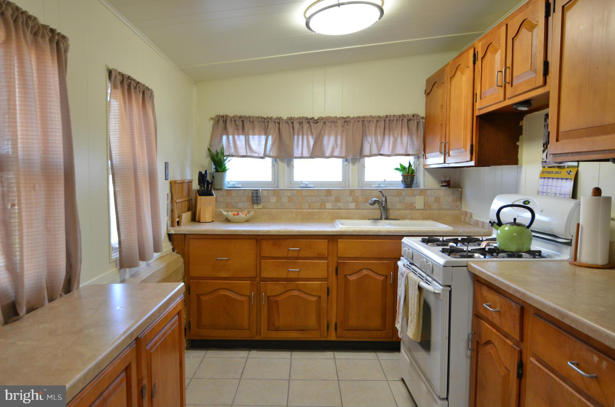 600 Old Riverside Road Baltimore, MD 21225 - Photo 4 of 15 a kitchen with a sink stove and cabinets
