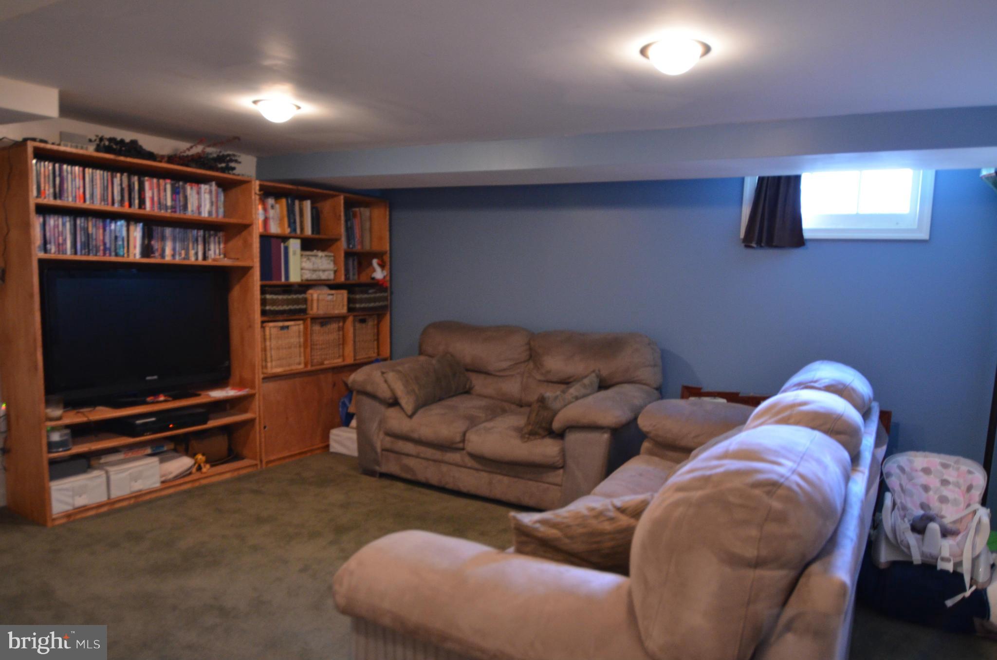 600 Old Riverside Road Baltimore, MD 21225 - Photo 6 of 15 a living room with furniture and a flat screen tv