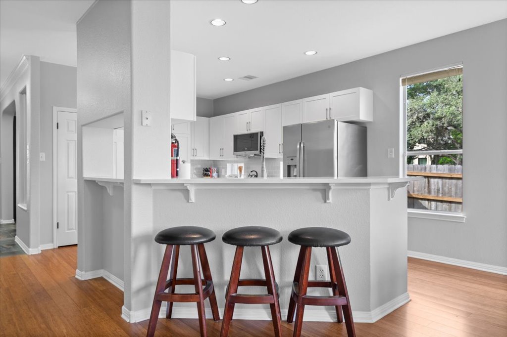 10801 Beachmont Lane Austin, TX 78739 - Photo 11 of 40 Pull up a bar stool to sip your morning coffee while you check your email on your laptop.