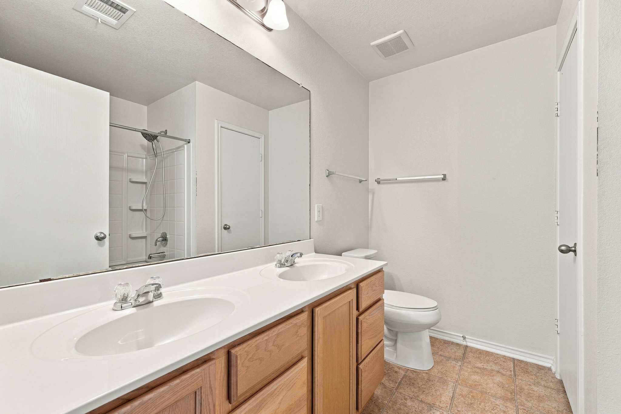 1141 Renaissance Trail Round Rock, TX 78665 - Photo 9 of 21 Functional vanity space features a dual-sink counter paired with neutral floor tiling.