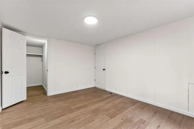 a view of an empty room and wooden floor